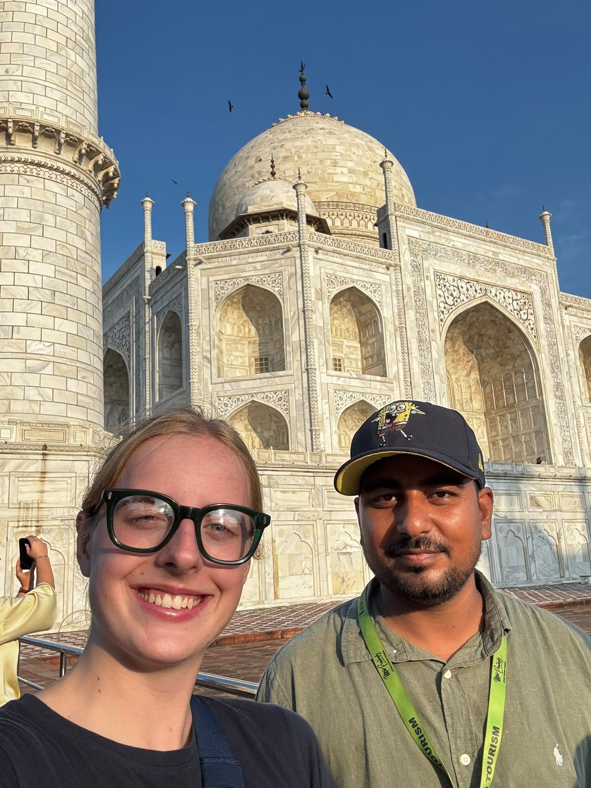 Tres viajeros posan frente al Taj Mahal en el tour de 9 días desde Delhi